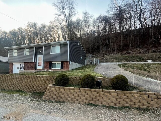 bi-level home with brick siding and an attached garage