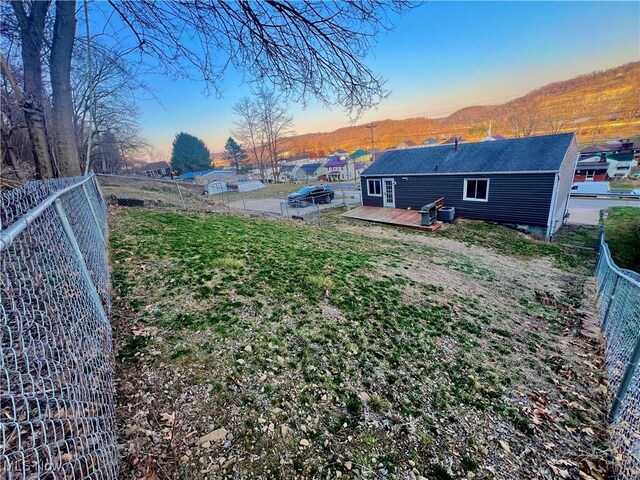 view of yard with a deck and fence