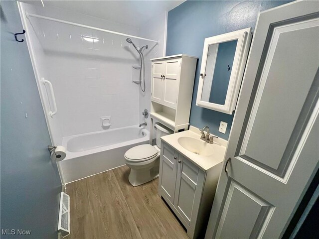 full bathroom featuring visible vents, toilet, shower / tub combination, wood finished floors, and vanity