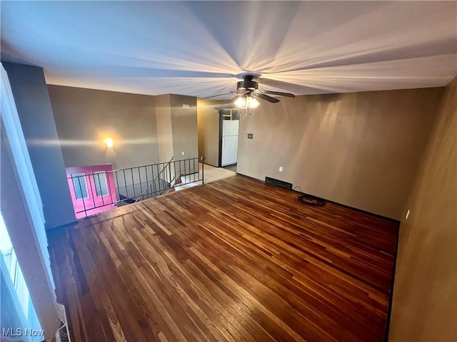 unfurnished room with wood finished floors and ceiling fan