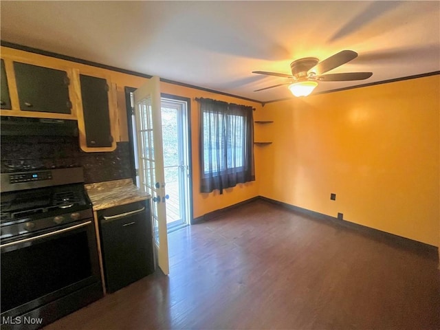 kitchen featuring a ceiling fan, backsplash, gas stove, baseboards, and dark wood-style flooring