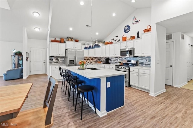 kitchen featuring white cabinetry, stainless steel appliances, and a sink