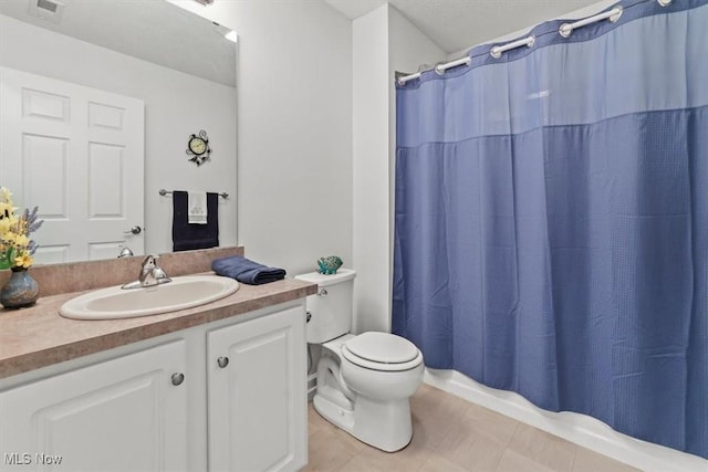 bathroom featuring visible vents, toilet, a shower with shower curtain, tile patterned floors, and vanity