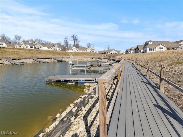 dock area with a residential view and a water view