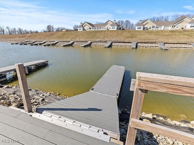 view of dock featuring a residential view and a water view