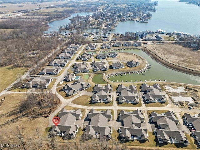 birds eye view of property with a water view and a residential view