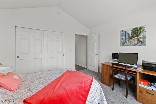 carpeted bedroom featuring a closet and vaulted ceiling