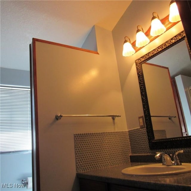 bathroom with backsplash and vanity