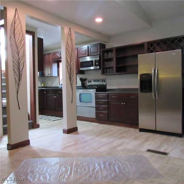 kitchen with dark countertops, visible vents, dark brown cabinets, stainless steel appliances, and open shelves