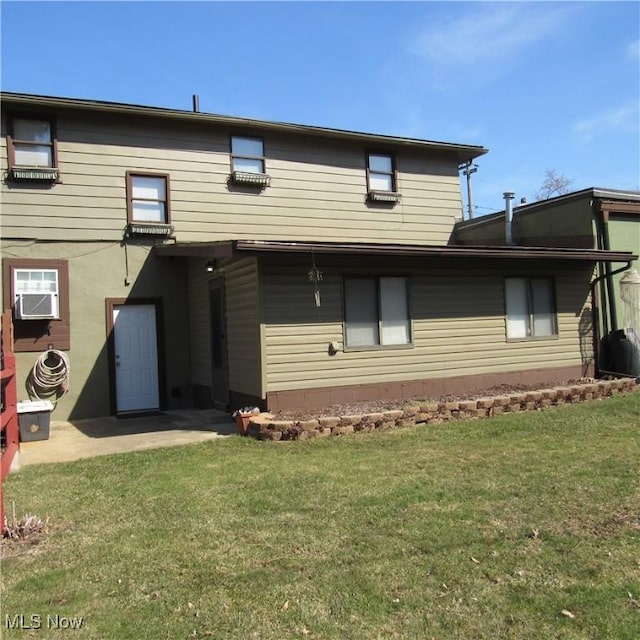 rear view of property featuring cooling unit and a yard