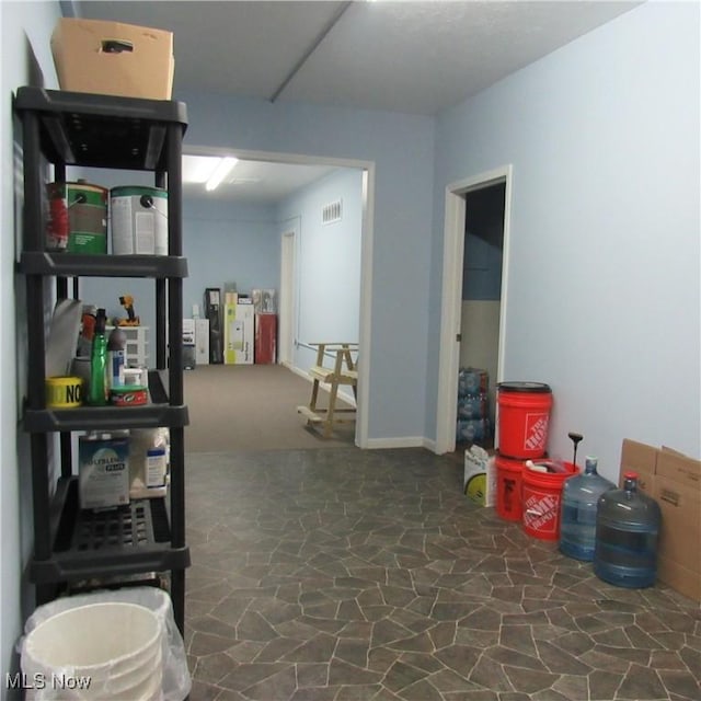 basement with stone finish floor and visible vents