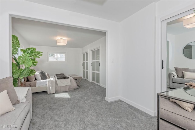 carpeted living room with baseboards