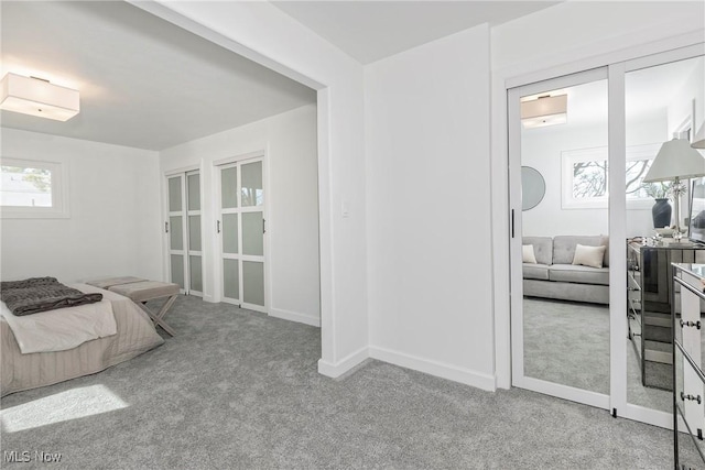 carpeted bedroom with baseboards