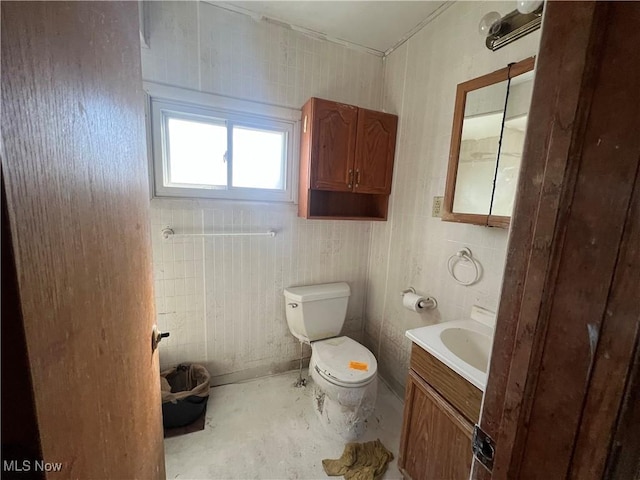 half bathroom with vanity, toilet, and unfinished concrete flooring