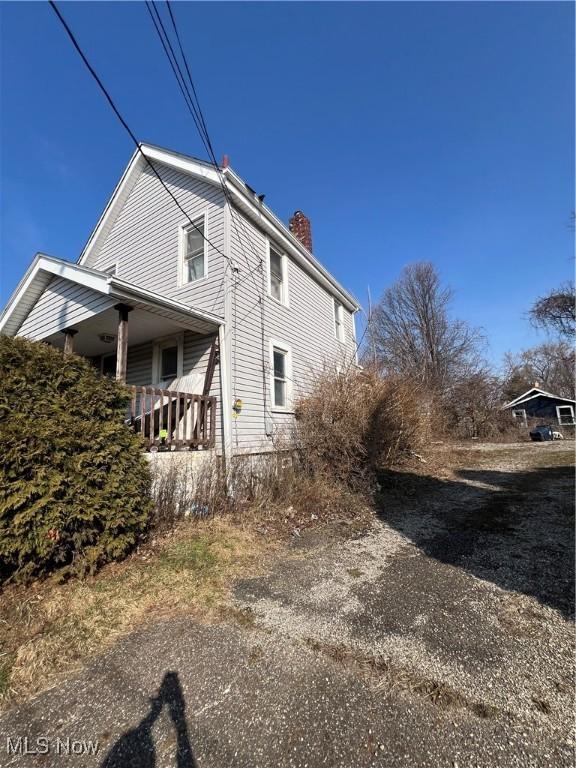 view of property exterior featuring a chimney