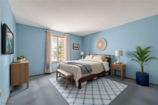 bedroom featuring carpet flooring, a textured ceiling, and baseboards