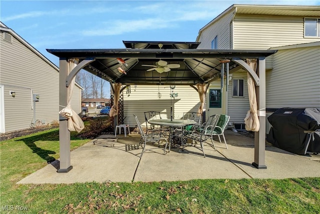 view of patio featuring a gazebo, area for grilling, outdoor dining area, and a ceiling fan