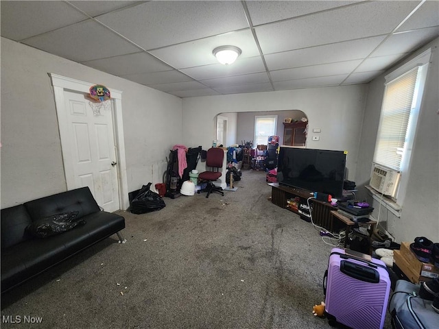 interior space with a wealth of natural light, cooling unit, a paneled ceiling, and carpet floors