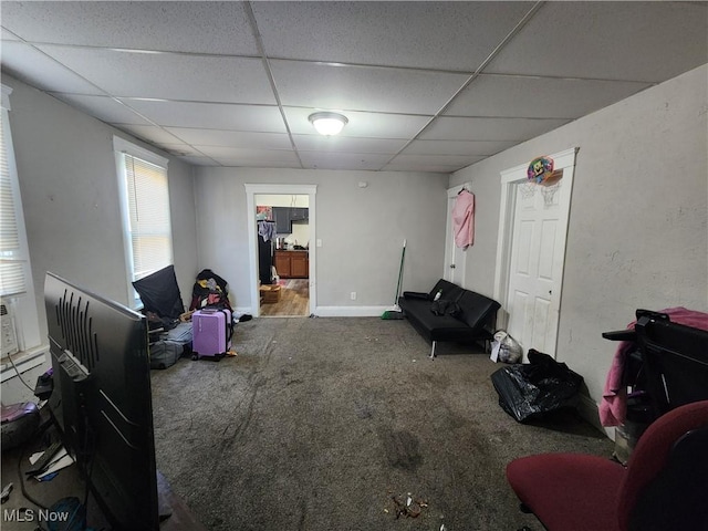 sitting room with carpet, baseboards, and a paneled ceiling