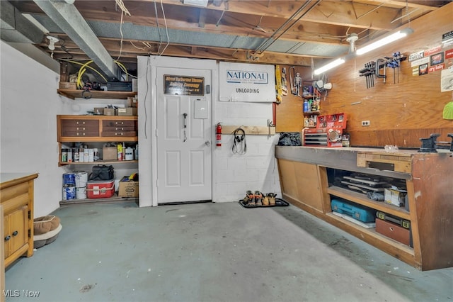 interior space with a workshop area and concrete block wall