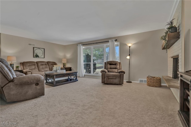 carpeted living area featuring visible vents, a fireplace, and baseboards