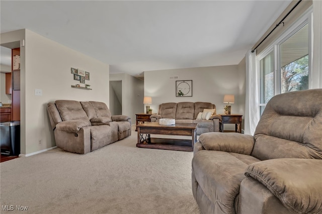 living room with visible vents, baseboards, and carpet floors