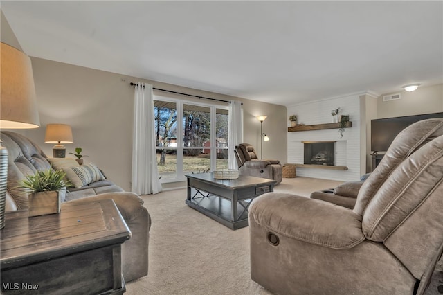 living room with light carpet, visible vents, and a fireplace