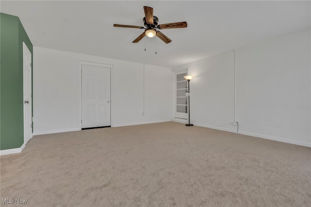 empty room with baseboards, light colored carpet, and ceiling fan