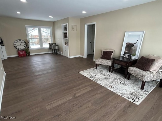 sitting room with dark wood finished floors, recessed lighting, and baseboards