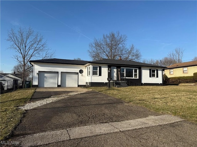 ranch-style house with aphalt driveway, a garage, and a front yard