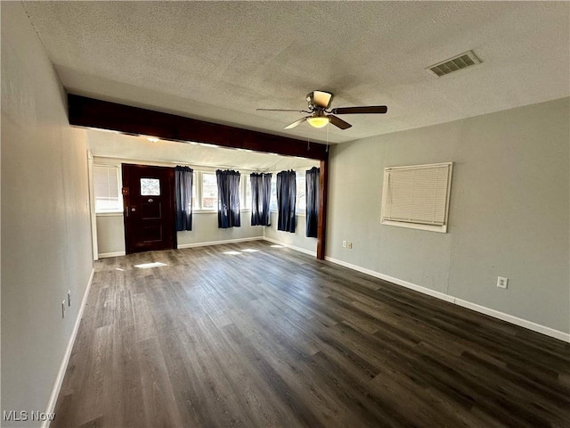 unfurnished room with dark wood finished floors, baseboards, and visible vents