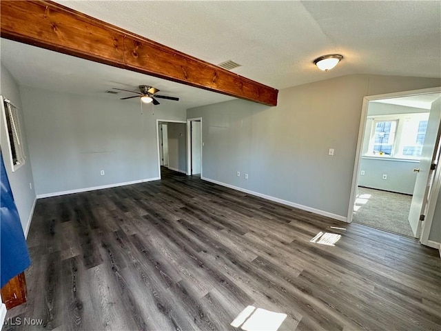 interior space with baseboards, visible vents, dark wood-style flooring, and a textured ceiling