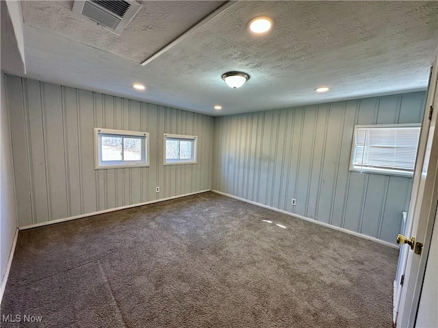 unfurnished room featuring visible vents, recessed lighting, a textured ceiling, and carpet