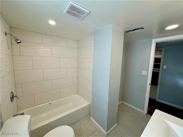 bathroom with visible vents, toilet,  shower combination, tile patterned flooring, and baseboards