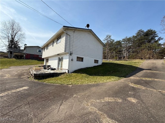 view of home's exterior with a yard