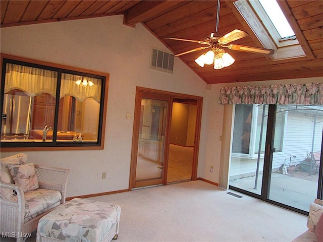 sitting room with lofted ceiling with skylight, wood ceiling, visible vents, and light carpet