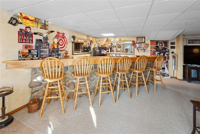 bar with a drop ceiling, baseboards, carpet, and a dry bar