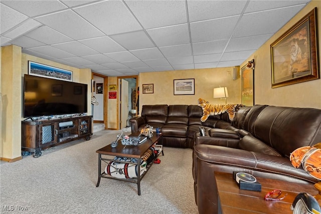 living room with baseboards, a paneled ceiling, and carpet