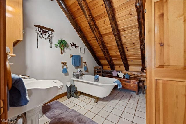 full bath featuring tile patterned flooring, lofted ceiling with beams, a freestanding bath, and wood ceiling