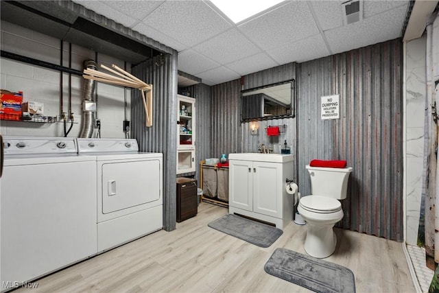 washroom featuring light wood finished floors, visible vents, laundry area, independent washer and dryer, and a sink