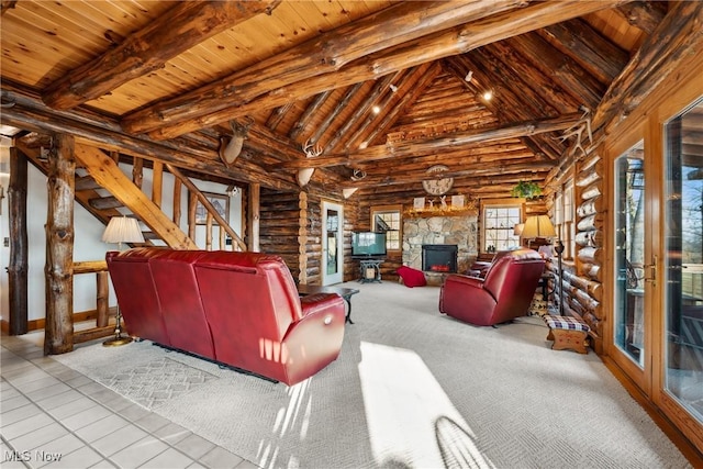 living room with beam ceiling, stairway, wooden ceiling, and a stone fireplace