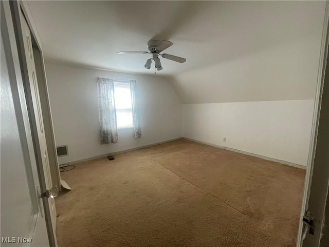 additional living space with ceiling fan, baseboards, lofted ceiling, and carpet