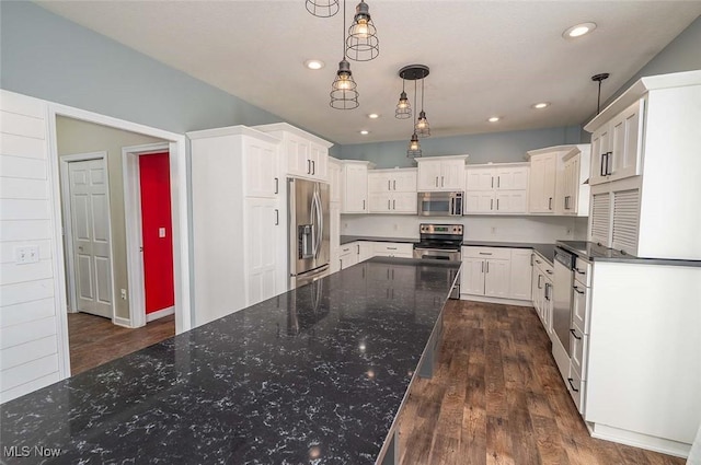 kitchen with dark wood-type flooring, pendant lighting, recessed lighting, white cabinets, and stainless steel appliances