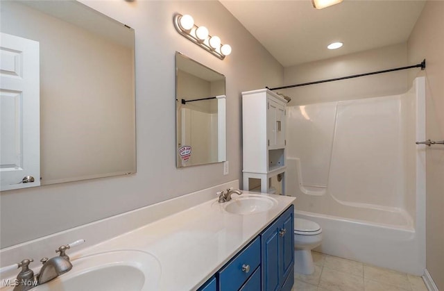 bathroom featuring tile patterned floors, toilet, double vanity, and a sink