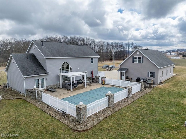 rear view of house featuring a fenced in pool, a lawn, a fenced backyard, a pergola, and a patio