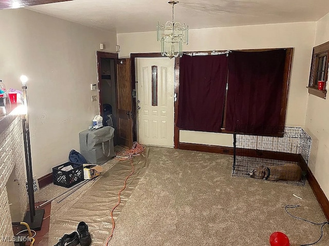 interior space with baseboards and a notable chandelier