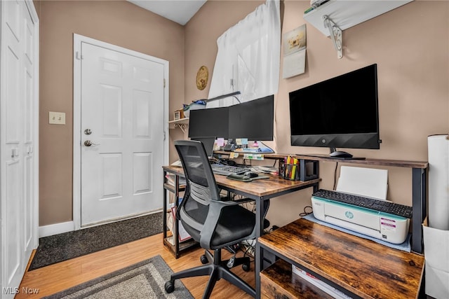 office featuring baseboards and wood finished floors