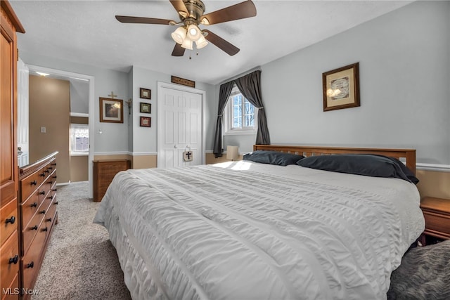 bedroom featuring a ceiling fan, a closet, and carpet floors