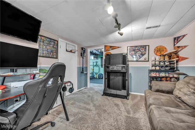 office area featuring rail lighting, visible vents, wainscoting, and carpet flooring