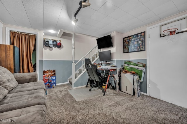 carpeted office space with wainscoting and rail lighting